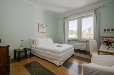 a bedroom with a white bed and a window at Vatican Zen House - Cale 05 in Rome