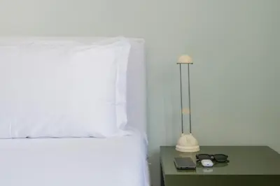 a bedroom with a bed and a lamp on a table at Vatican Zen House - Cale 05 in Rome