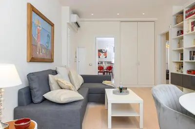 a living room with a couch and a table at San Pietro Nausicaa Penthouse in Rome