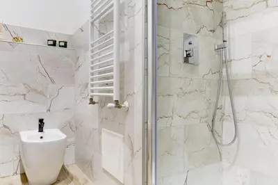a bathroom with a shower and a toilet and a sink at San Giovanni Cozy Apt - Home and More in Rome