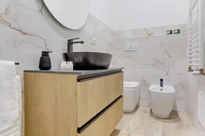 a bathroom with a sink and a toilet at San Giovanni Cozy Apt - Home and More in Rome