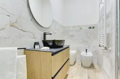 a bathroom with a sink and a toilet at San Giovanni Cozy Apt - Home and More in Rome