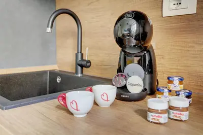 a coffee maker sitting on a counter next to cups at San Giovanni Cozy Apt - Home and More in Rome