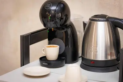 a coffee maker and a cup of coffee on a counter at Flowery Rainbow in Rome