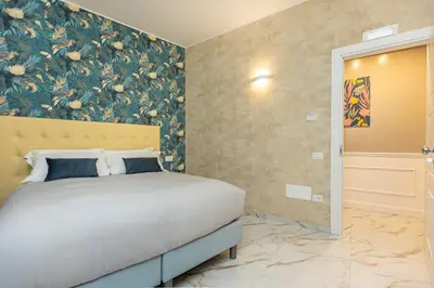 a bedroom with a bed with a floral wallpaper at Flowery Rainbow in Rome
