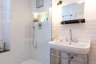 a white bathroom with a sink and a shower at Boho 202 in Rome