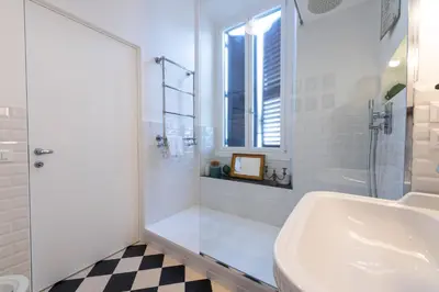 a white bathroom with a tub and a sink at Boho 202 in Rome