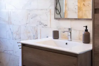 a bathroom with a sink and a mirror at Delia's Vatican House Near St Peter's in Rome