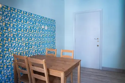 a dining room with a wooden table and chairs at Delia's Vatican House Near St Peter's in Rome