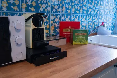 a kitchen counter with a coffee maker on a counter top at Delia's Vatican House Near St Peter's in Rome