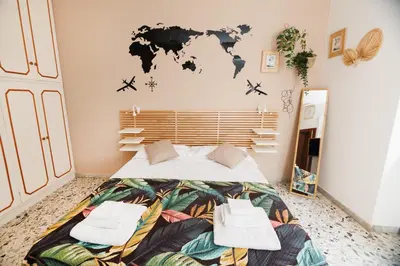 a bedroom with a bed with a world map on the wall at RHOME SUITE VATICAN APTS in Rome
