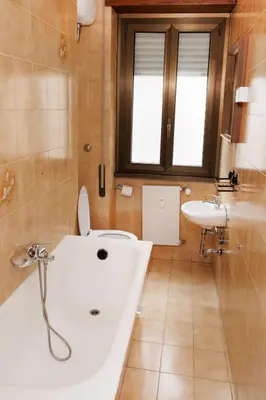 a bathroom with a white tub and a sink at RHOME SUITE VATICAN APTS in Rome