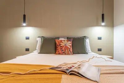 a bedroom with a bed with a book on it at YCH-Ambra Apartments a San Giovanni in Rome
