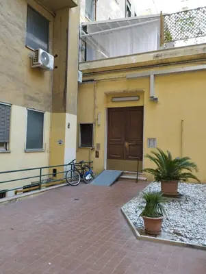 a building with a bike parked in front of a door at YCH-Ambra Apartments a San Giovanni in Rome