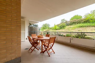 a patio with a table and chairs on a balcony at Bonum Vitae in Rome
