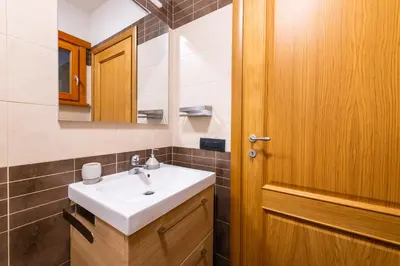 a bathroom with a sink and a wooden door at Bonum Vitae in Rome