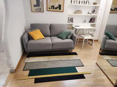 a living room with a couch and a table at Appartamento Loft ex mulini in Rome