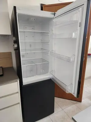 an empty refrigerator with its door open in a kitchen at Appartamento Loft ex mulini in Rome