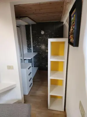 a room with a closet with shelves and a wall at Appartamento Loft ex mulini in Rome