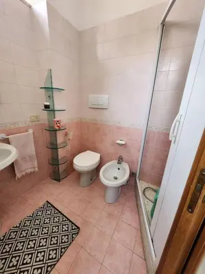 a bathroom with a toilet and a sink at Appartamento Loft ex mulini in Rome