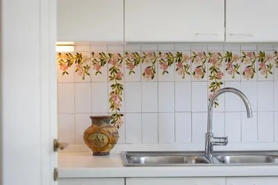 a kitchen with a sink and a vase on the counter at Tre Lune Penthouse by Rental in Roma in Rome