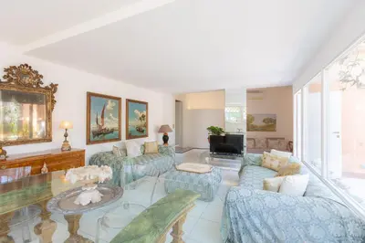a living room with blue couches and a glass table at Tre Lune Penthouse by Rental in Roma in Rome