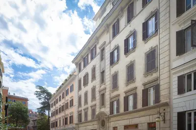a tall building with windows on a city street at Tre Lune Penthouse by Rental in Roma in Rome