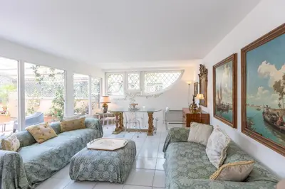 a living room with two couches and a table at Tre Lune Penthouse by Rental in Roma in Rome