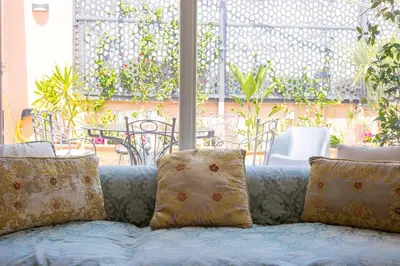 a couch with pillows sitting in front of a patio at Tre Lune Penthouse by Rental in Roma in Rome