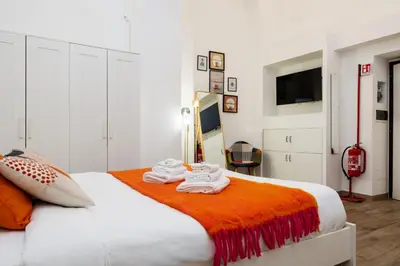 a bedroom with a bed with towels on it at Archetto by the Vatican in Rome