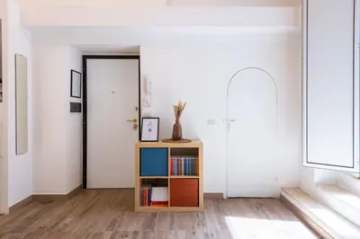 a room with a book shelf and a door at Archetto by the Vatican in Rome
