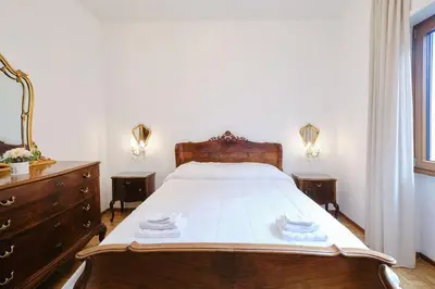 a bedroom with a bed and a dresser and a window at Monteverde - Vaticano - Esperienza Romana 1BDR by Hôtea in Rome