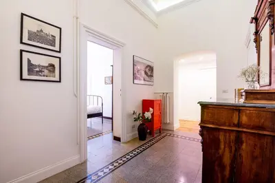 a living room with a wooden podium in a room at Quirino Visconti Apartment Prati in Rome