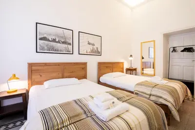two beds in a room with white walls at Quirino Visconti Apartment Prati in Rome