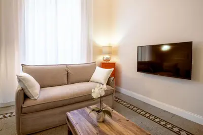 a living room with a couch and a coffee table at Quirino Visconti Apartment Prati in Rome