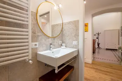 a bathroom with a white sink and a mirror at Quirino Visconti Apartment Prati in Rome