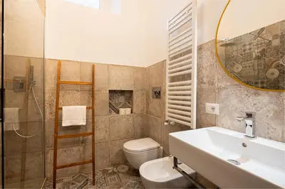 a bathroom with a sink and a toilet and a mirror at Quirino Visconti Apartment Prati in Rome