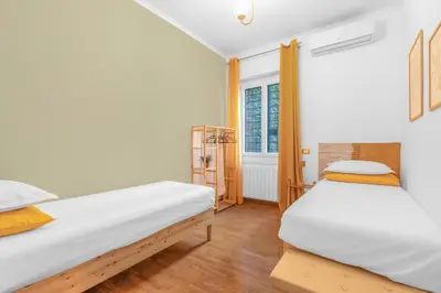two beds in a room with a window at Conca D'Oro Terrace in Rome