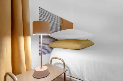 a bedroom with a bed and a table with a lamp at Conca D'Oro Terrace in Rome