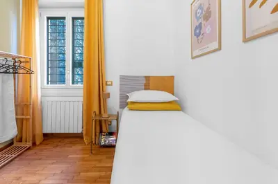 a small bedroom with a bed and a window at Conca D'Oro Terrace in Rome