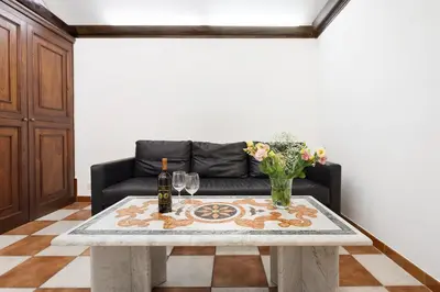 a living room with a table and a couch at Campitelli 9 - Loft in Ancient Rome in Rome