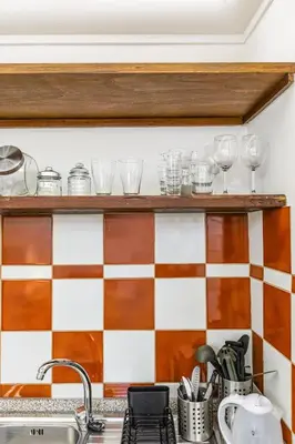 a kitchen with a checkered wall at Campitelli 9 - Loft in Ancient Rome in Rome
