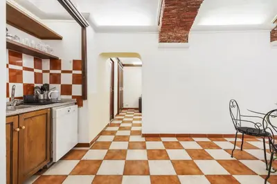a kitchen with a checkered floor at Campitelli 9 - Loft in Ancient Rome in Rome