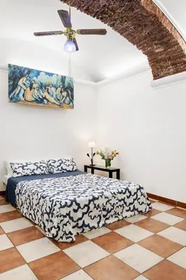 a bedroom with a bed and a ceiling fan at Campitelli 9 - Loft in Ancient Rome in Rome