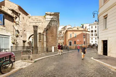 a group of people walking down a cobblestone street at Campitelli 9 - Loft in Ancient Rome in Rome