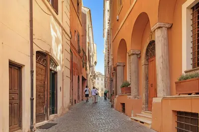 two people walking down a street in an alley at Campitelli 9 - Loft in Ancient Rome in Rome