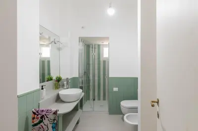 a bathroom with two toilets and a sink at iFlat Trastevere Stylish 4 Bedroom Penthouse in Rome