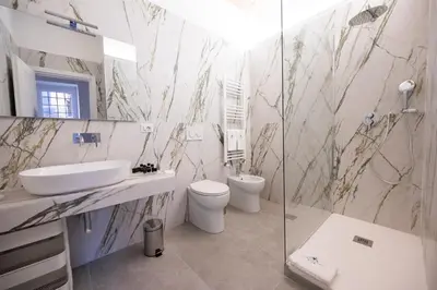 a bathroom with a sink and a toilet and a shower at Domus Laurina - Maison D'Art Collection in Rome