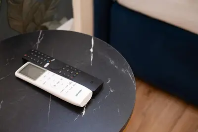 a remote control sitting on top of a table at Domus Laurina - Maison D'Art Collection in Rome