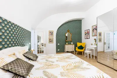 a bedroom with a large bed and a desk at Colosseum Boutique apartment in Rome